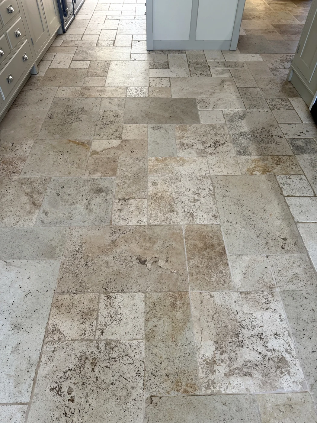 Closer view of the kitchen floor after restoration, with lighter grout lines