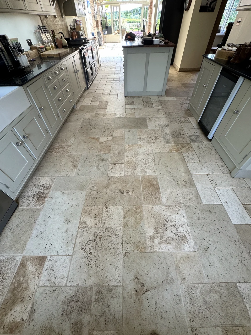The same kitchen floor viewed towards the peninsula, with lighter grout after restoration