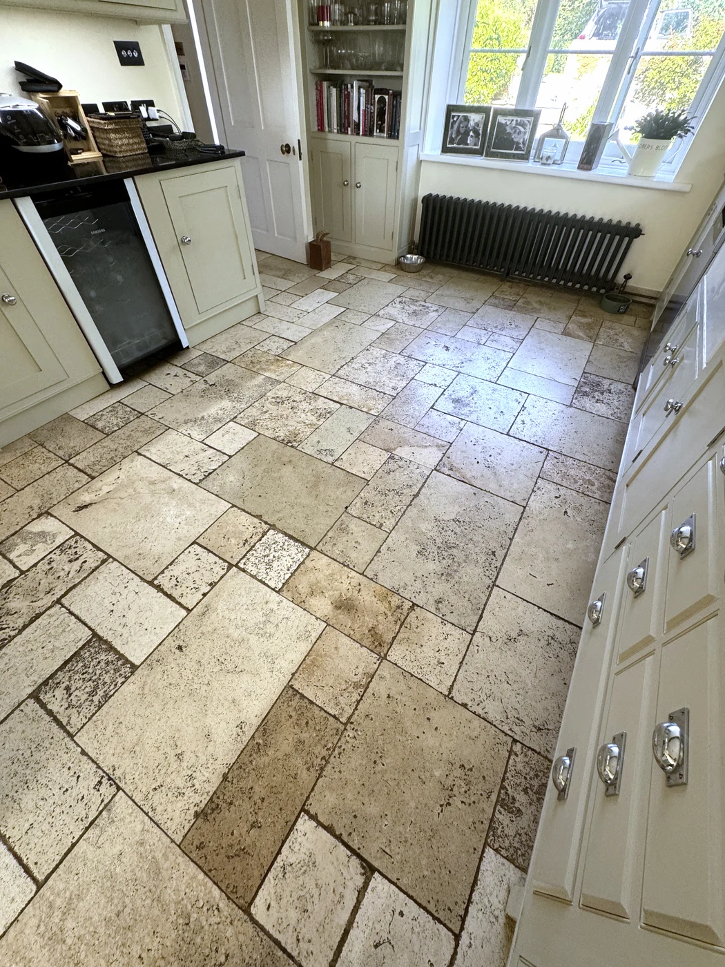 Additional view of the kitchen tiles before restoration, showing the dark grout