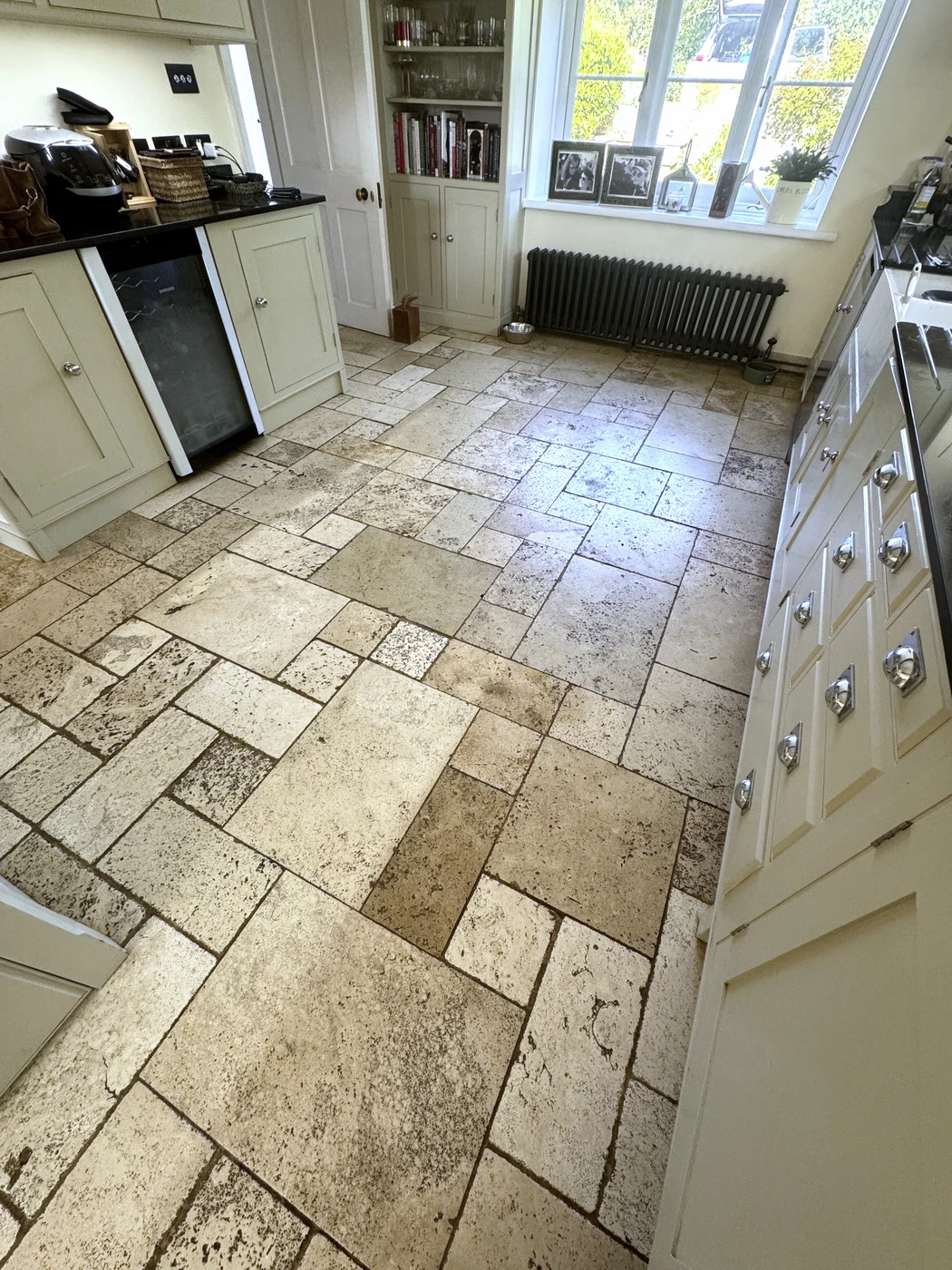 Wider view of the kitchen floor before restoration